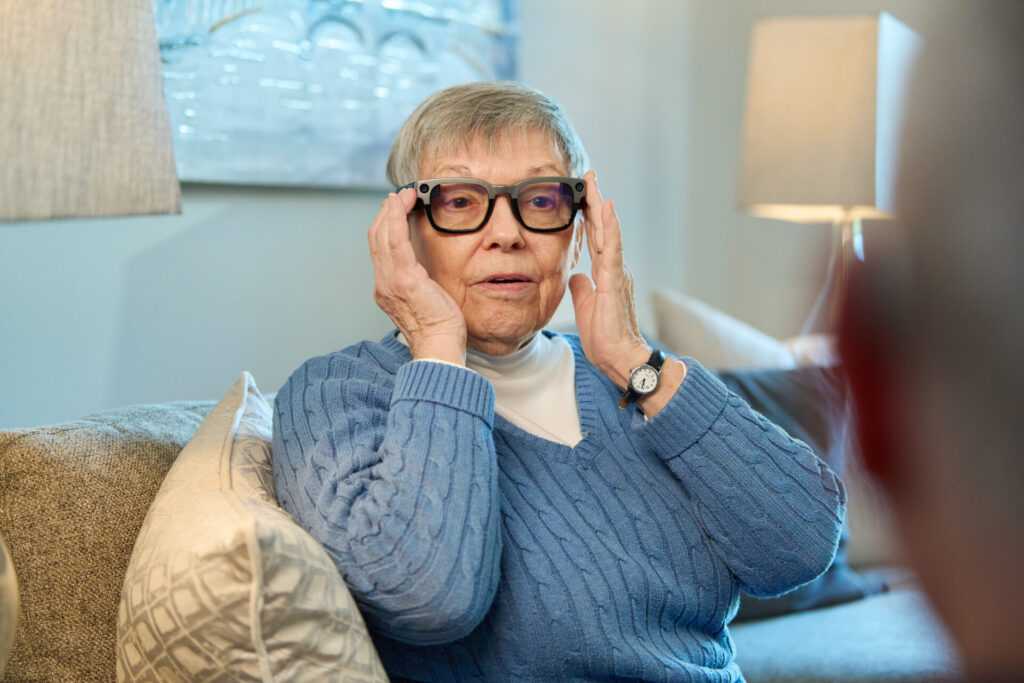 Asbury resident trying Xander closed-captioning glasses (one of AgeTech Collaborative from AARP's portfolio startups) - Photo credit Noah Willman