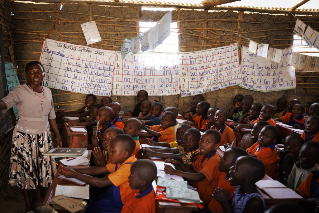 Children studying in makeshift tent that will be upgraded to a school as part of the Uganda Project