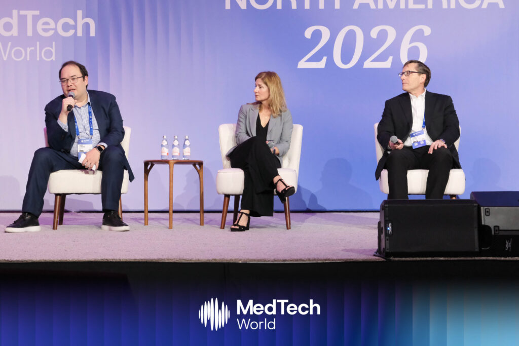 
Panelists on stage discussing how hospital venture funds provide more than capital, offering startups clinical access, validation pathways, and strategic partnerships